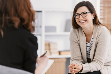 Counselor talking to smiling patient