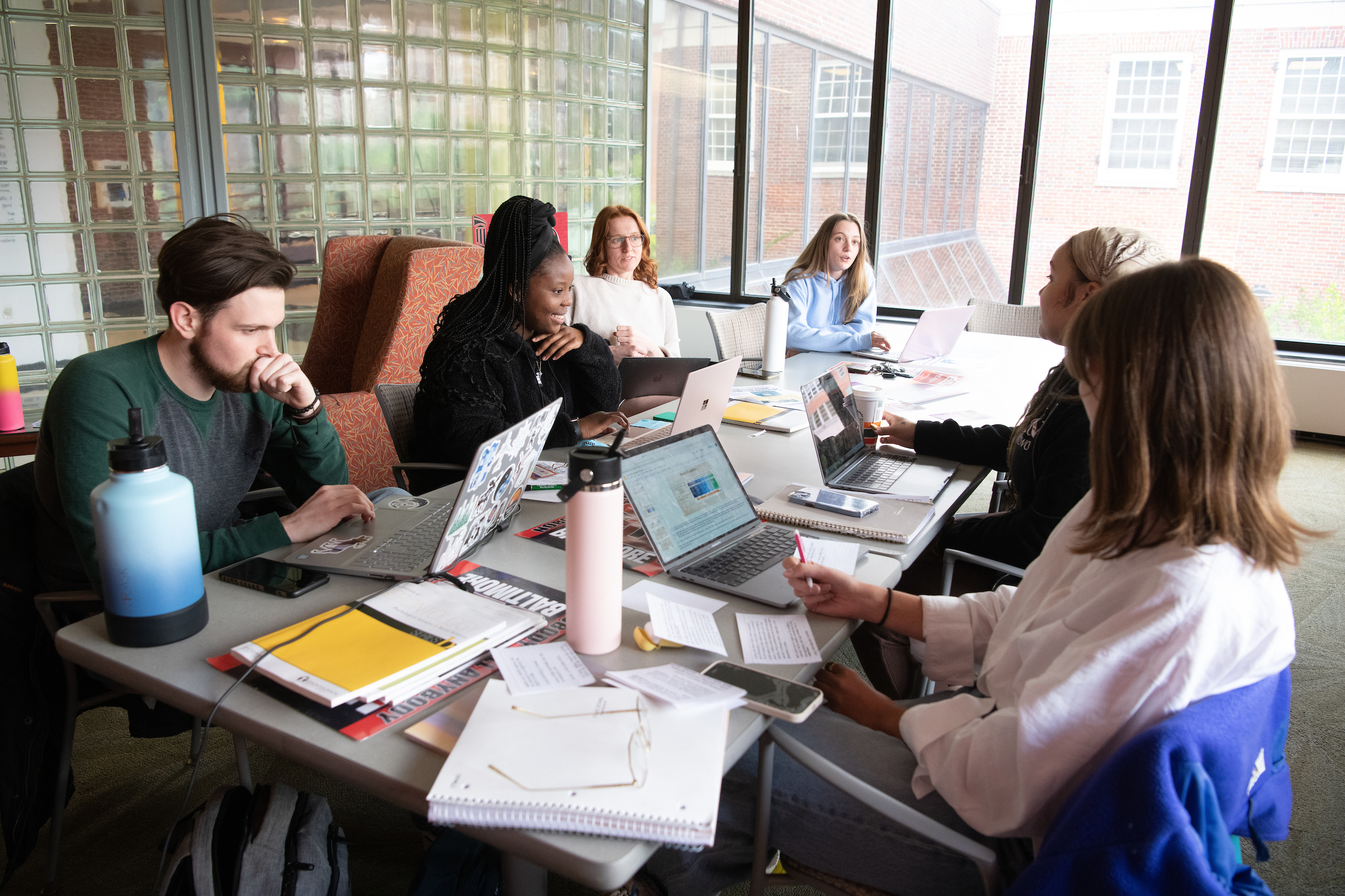 Social work students take a break in the student lounge of the SSW.