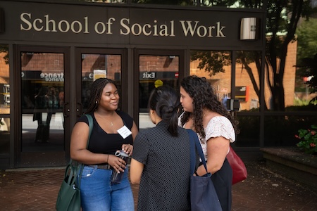 Women talking outside of SSW Building
