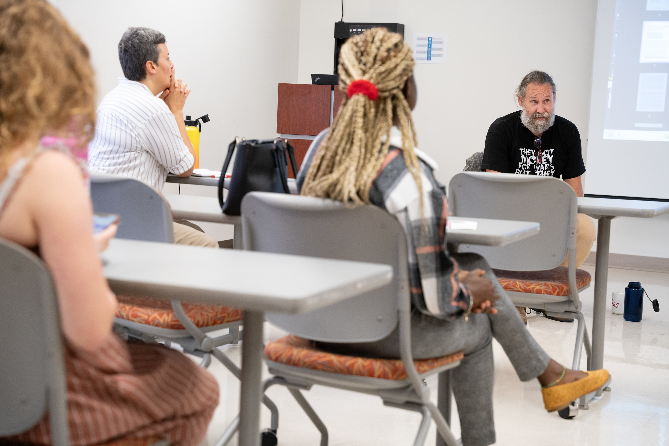 SSW classroom, students at desk professor sitting in chair.